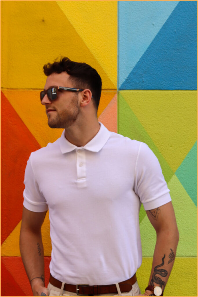Male model standing in front of artsy background