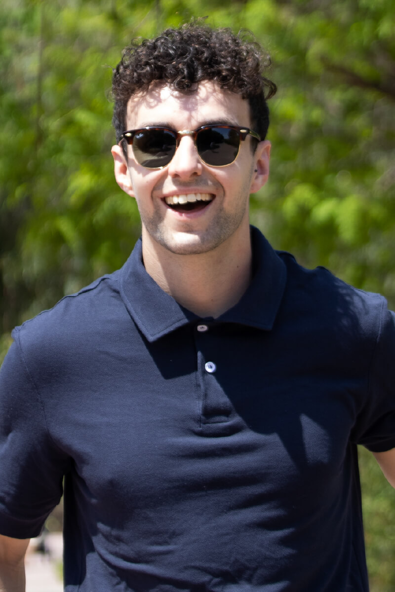 Model wearing navy blue Polo laughing.jpg Man in blue Polo shirt laughing